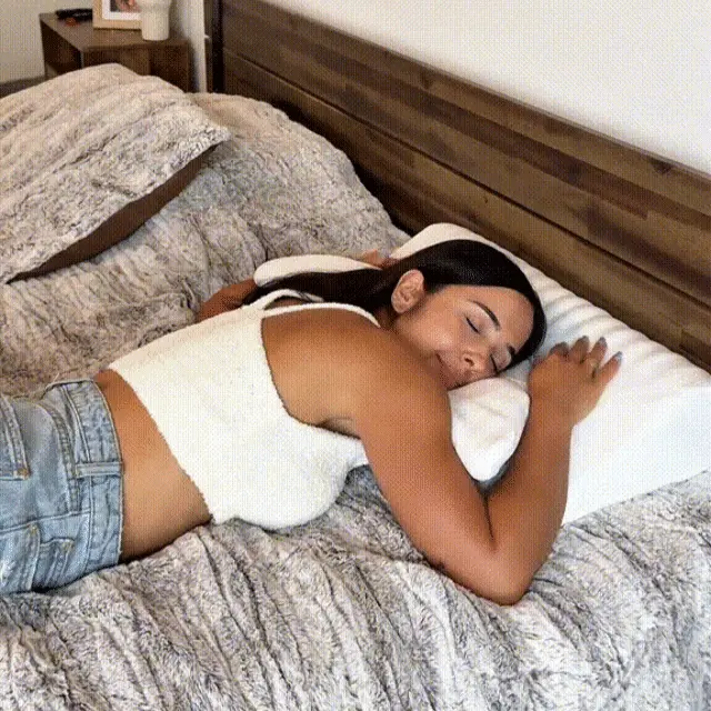Woman peacefully sleeping with anti-snoring pillow
